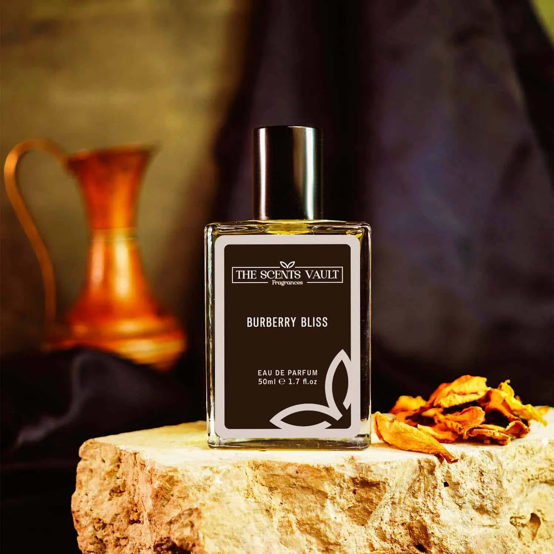 Burberry Bliss Eau de Parfum (50ml) from The Scents Vault, styled with natural wooden elements and a vintage copper jug, exuding an elegant, earthy ambiance.