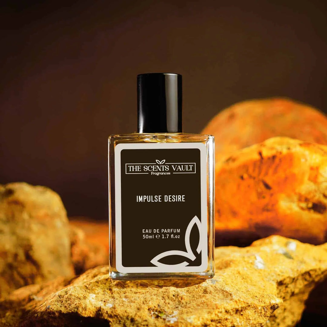 Impulse Desire Eau de Parfum (50ml) from The Scents Vault, displayed on a rustic rock background with a warm-toned backdrop.