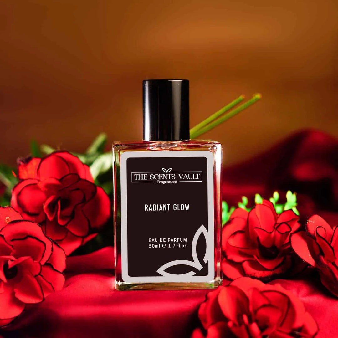 Radiant Glow Eau de Parfum (50ml) from The Scents Vault, displayed with red roses and a soft, warm background.