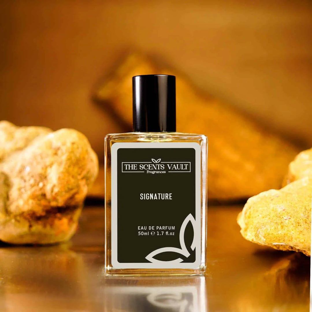 Signature eau de parfum by The Scents Vault, placed on textured stone surface, 50ml bottle.