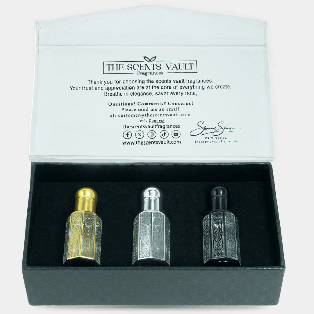 Three perfume bottles in a box with 'The Scents Vault' branding on the back.