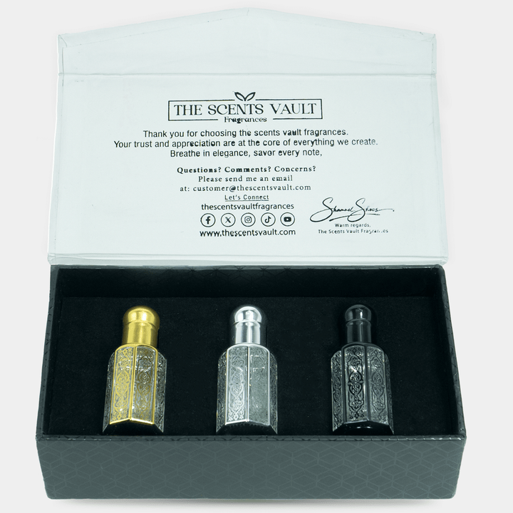 Three perfume bottles in a box with 'The Scents Vault' branding on the back.