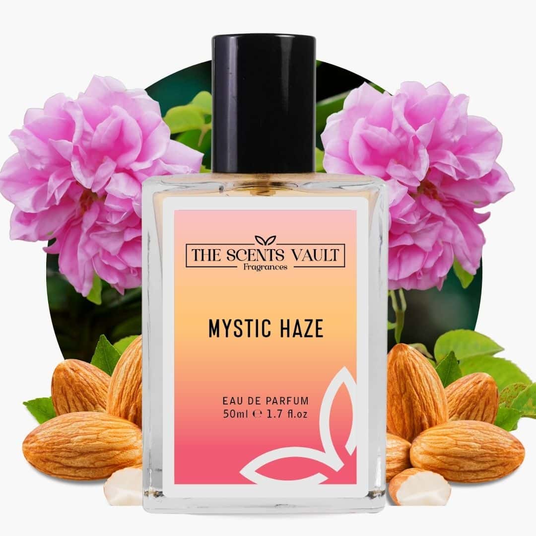 Perfume bottle labeled 'Mystic Haze' by 'The Scents Vault' with pink flowers and almonds in the background.