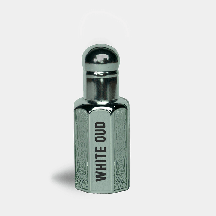 Silver and gray perfume bottle labeled 'White Oud' on a light gray background