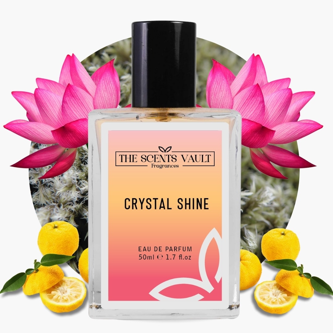 Perfume bottle labeled 'Crystal Shine' by 'The Scents Vault' with pink flowers and lemons in the background.