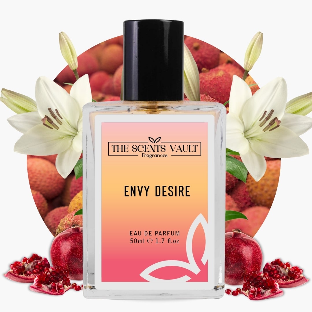 Perfume bottle labeled 'Envy Desire' by 'The Scents Vault' with pomegranates and flowers in the background.